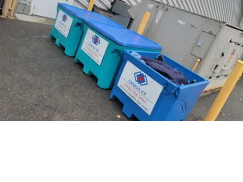 Three large blue bins are sitting on the ground.