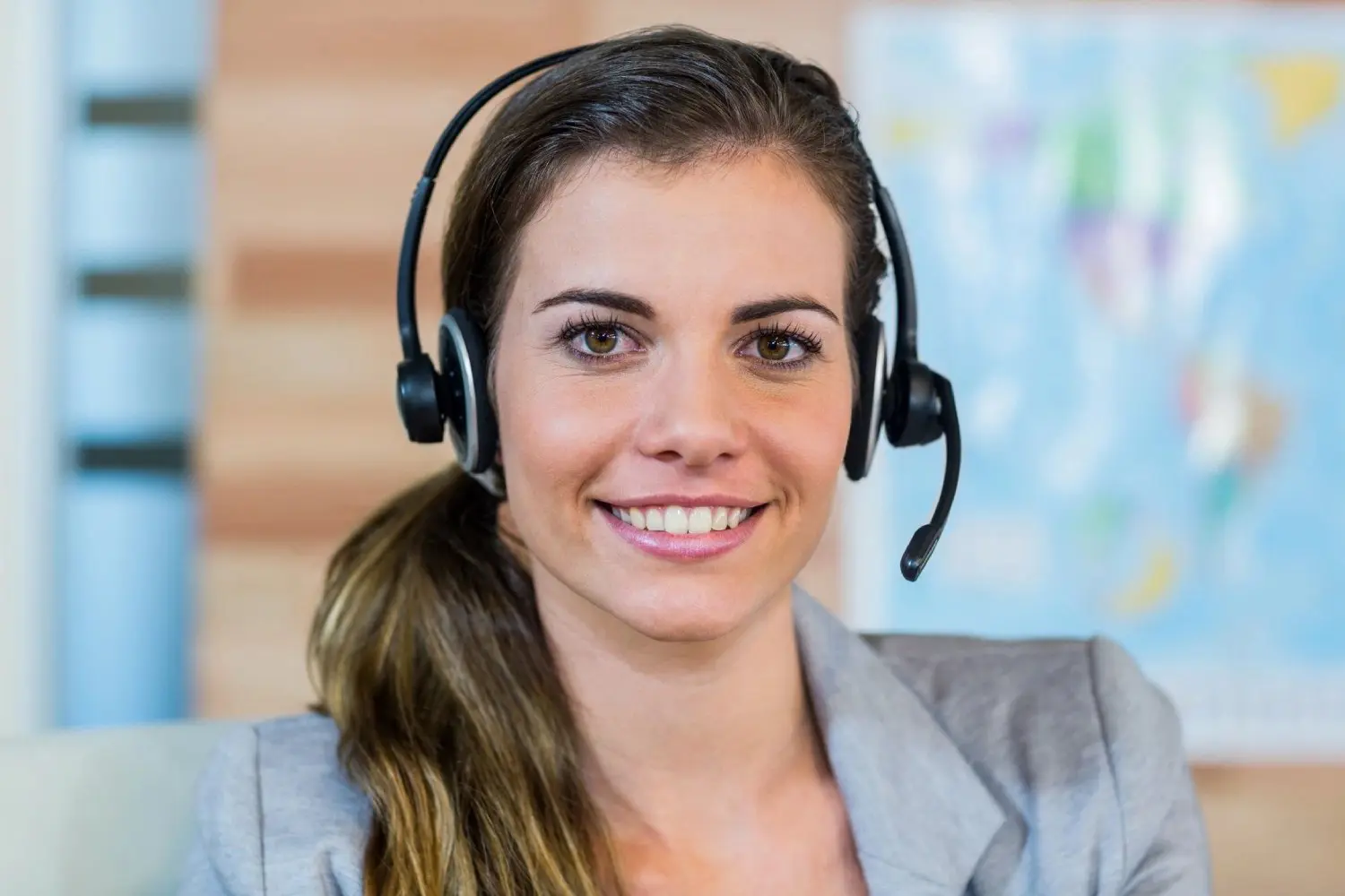 A woman wearing headphones and smiling for the camera.